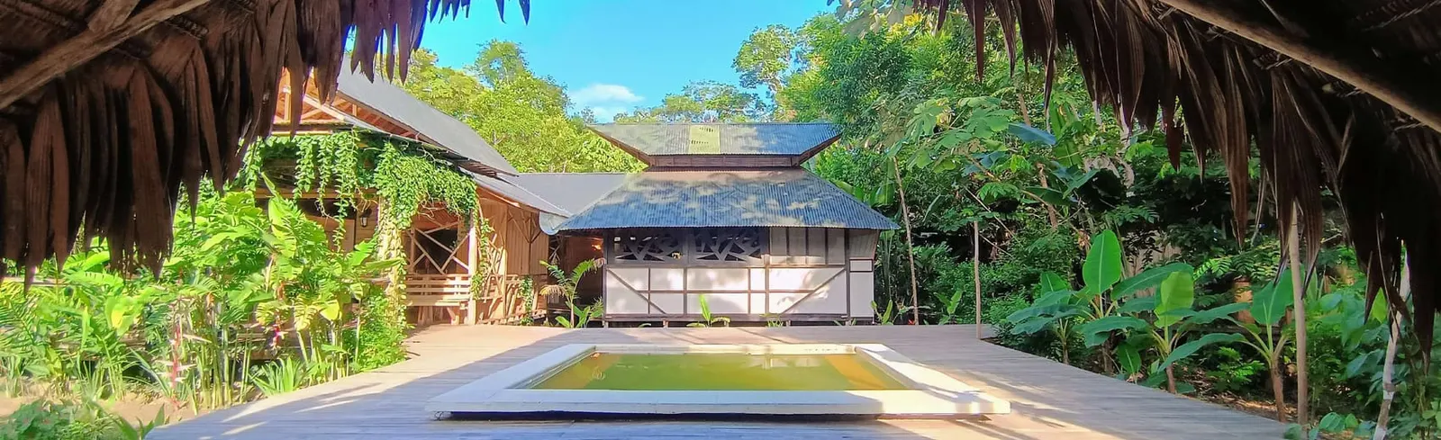 Burú Lodge wooden building with a pool surrounded by Amazon rainforest