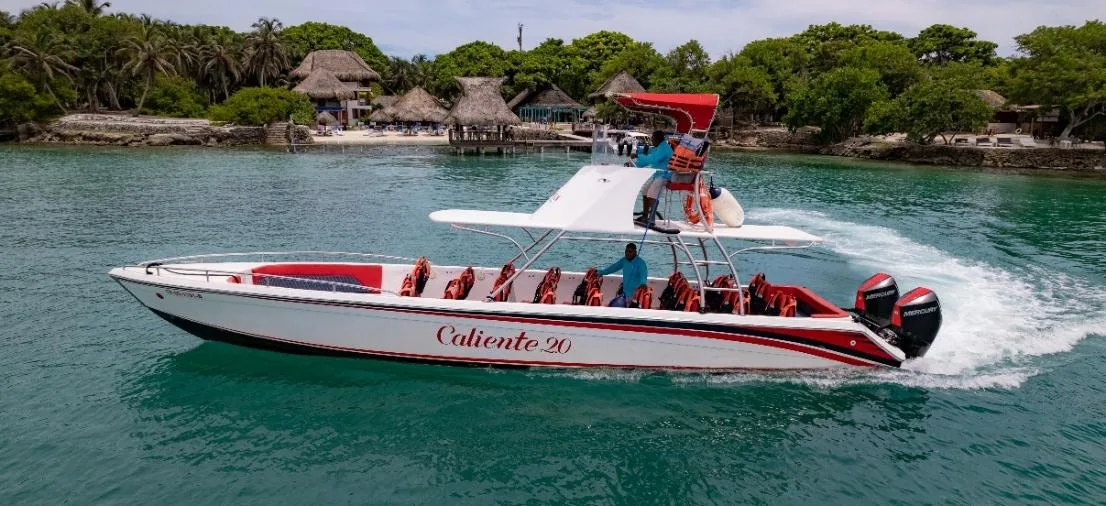 Fast boat with a red and white hull cruising near the Rosario Islands