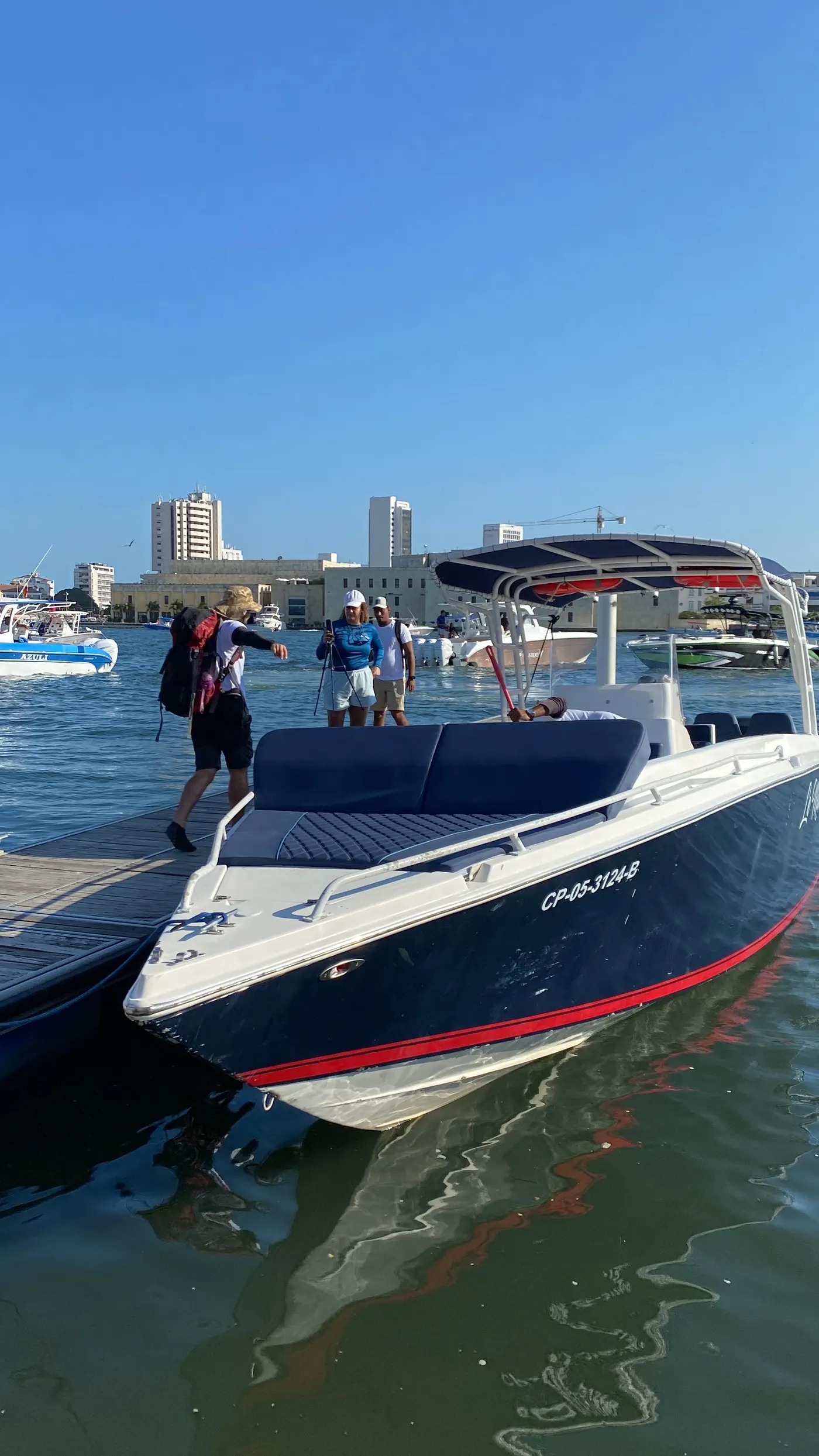 Sport boat docked at the pier while guests board