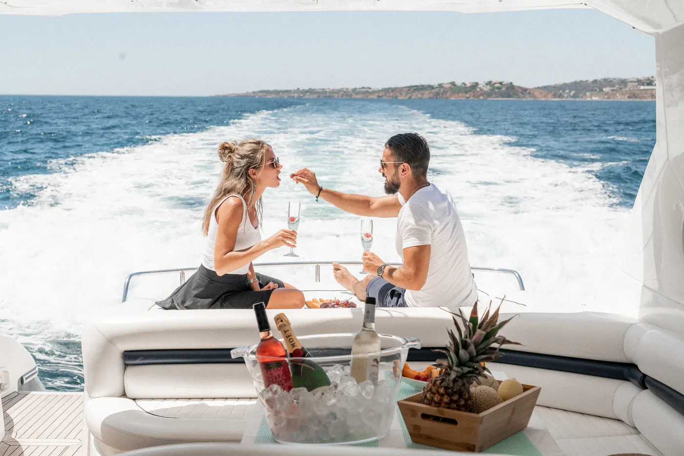 Couple toasting on the back deck of a boat