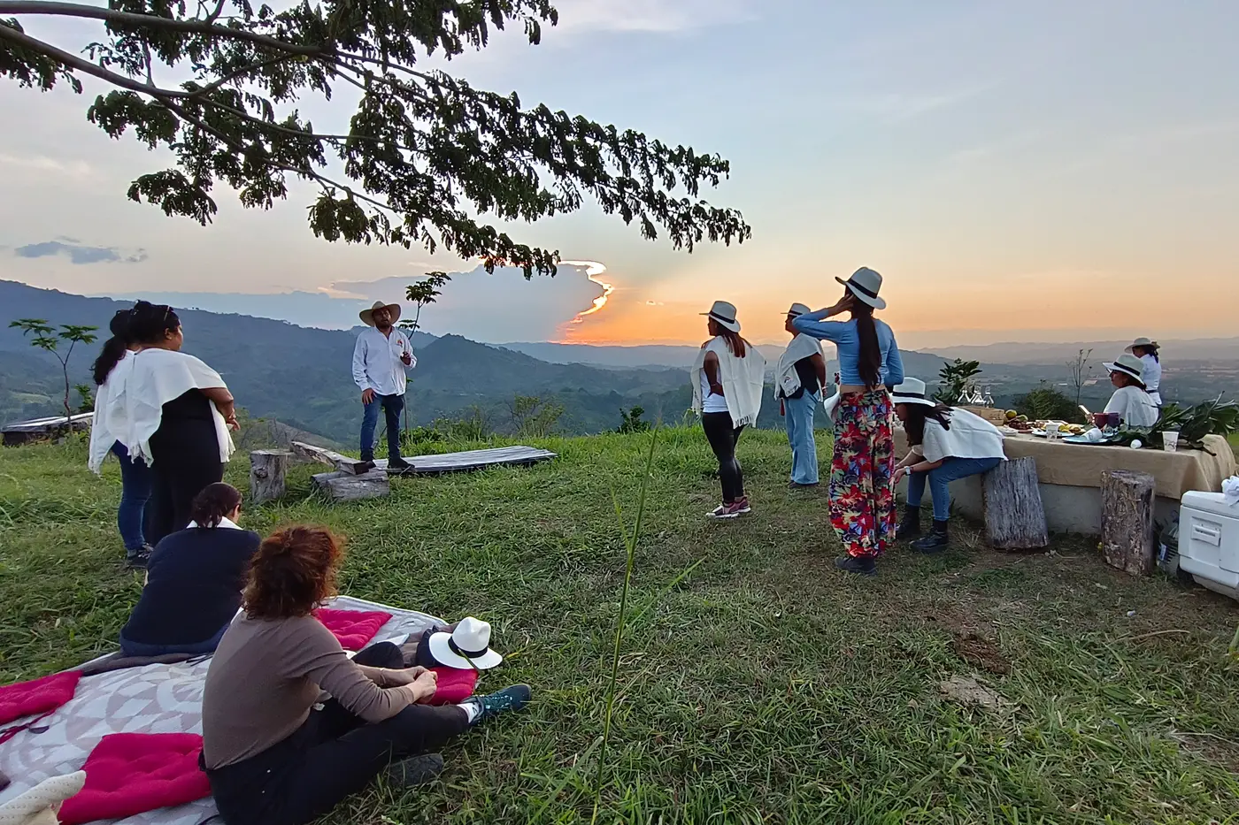 Picnic set on a green hilltop at sunset
