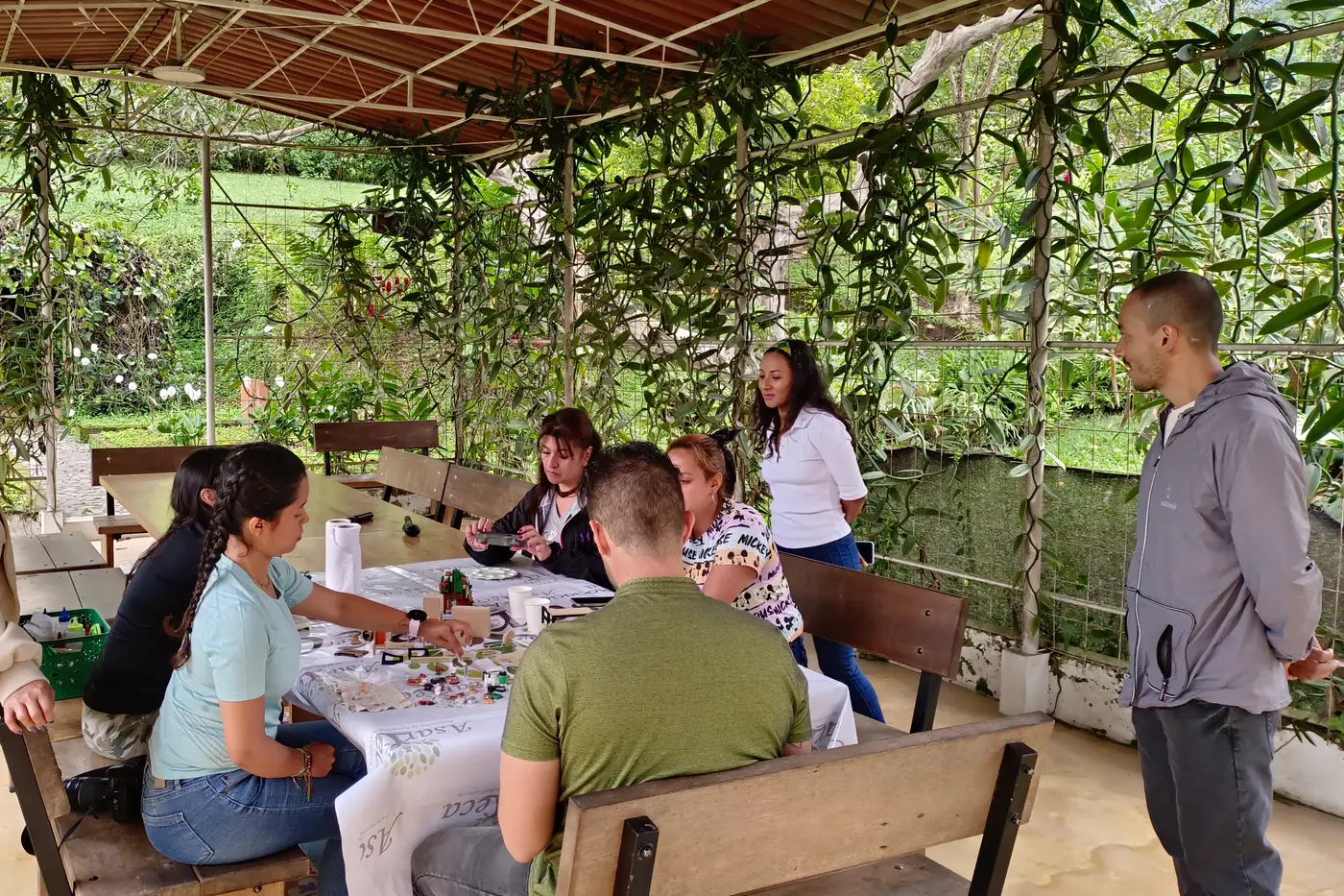 Travelers sharing a craft workshop at a long table with local artisans