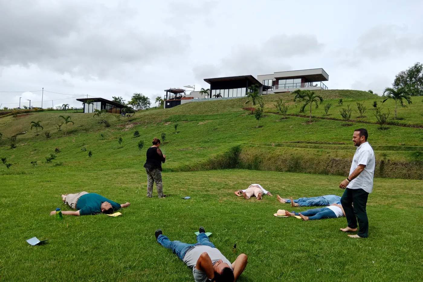 Participants lying on the grass during a wellness session