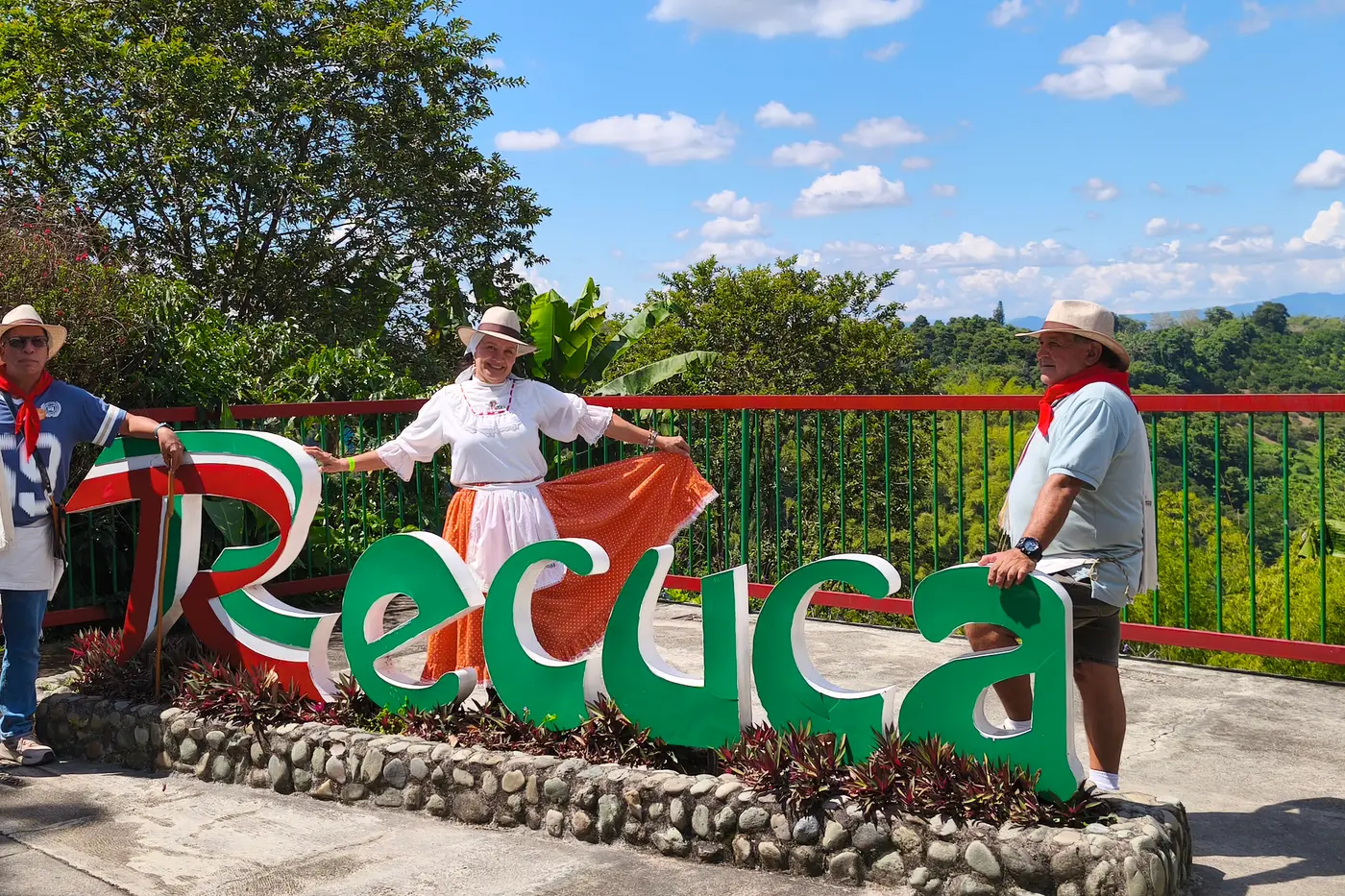 Costumed visitors at the RECUCA sign in the Coffee Region