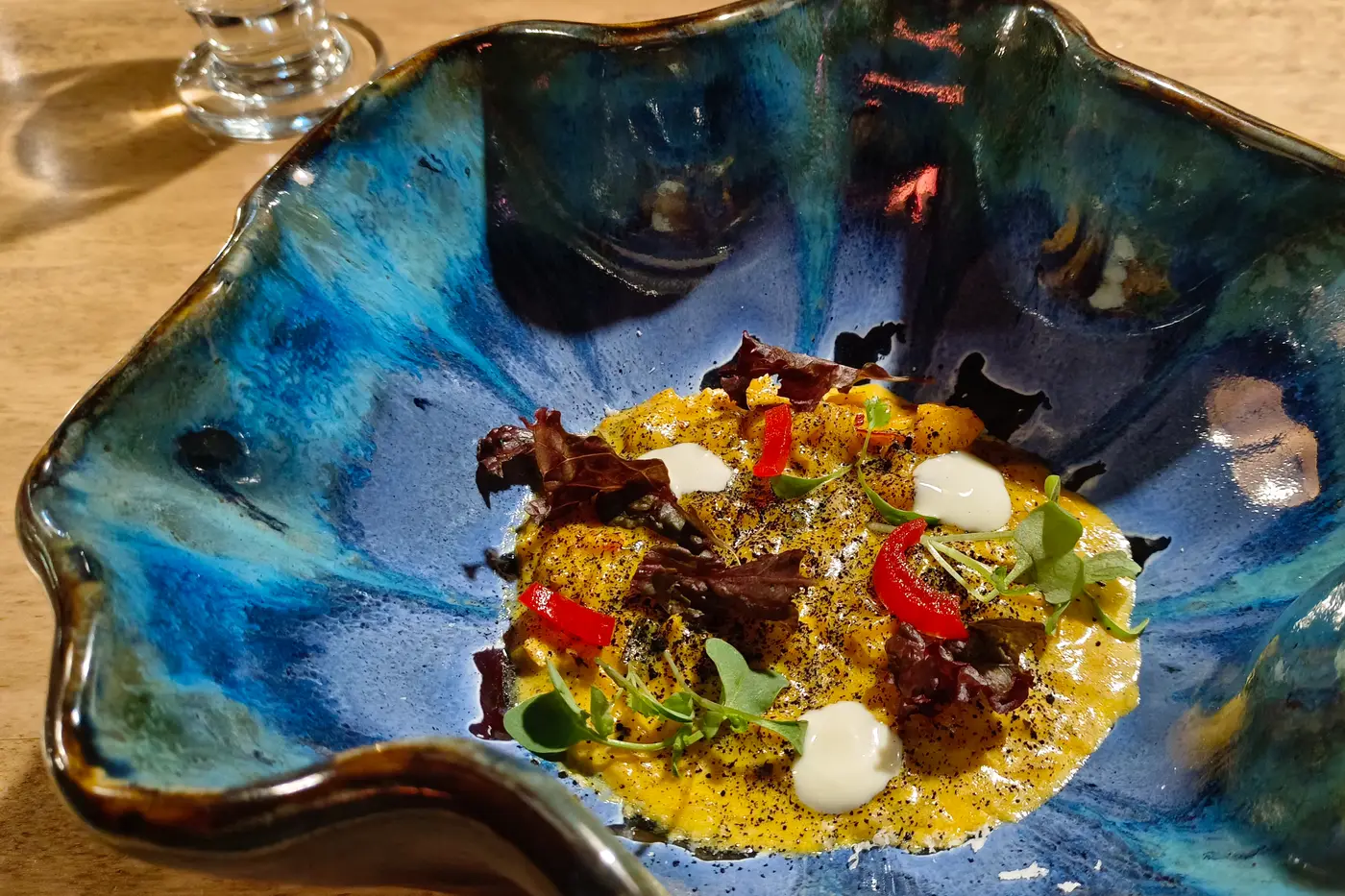 Chef-plated dish on a handmade ceramic bowl