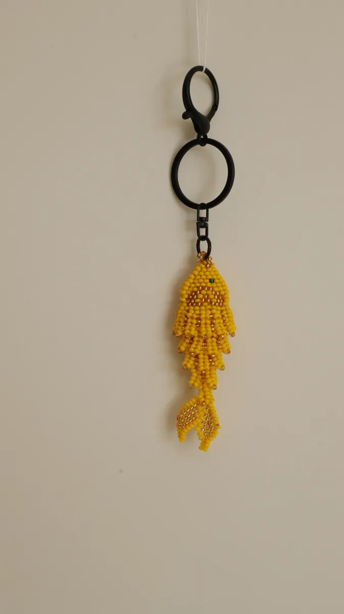 Yellow beaded fish keychain hanging