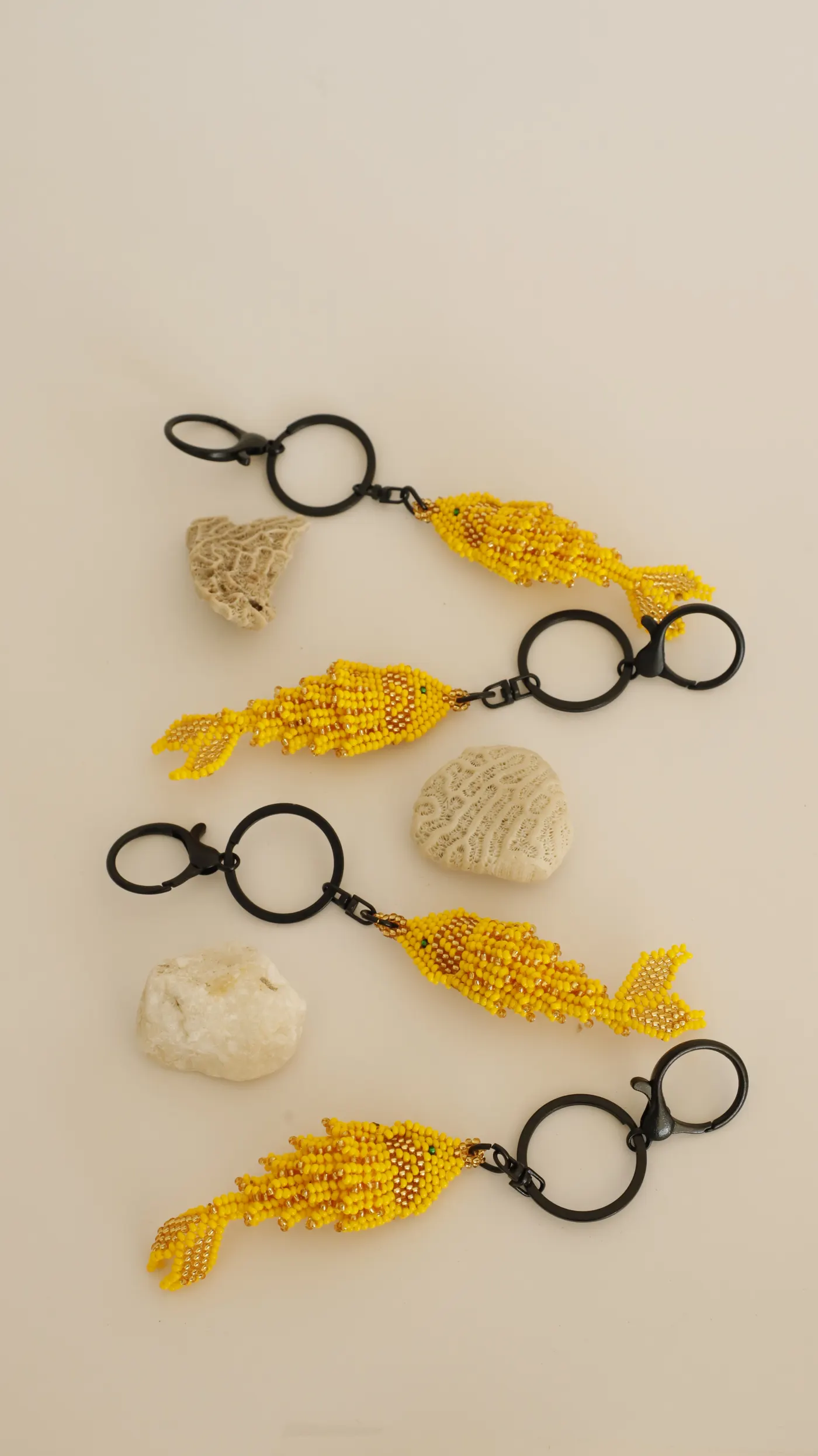 Three yellow beaded little fish keychains