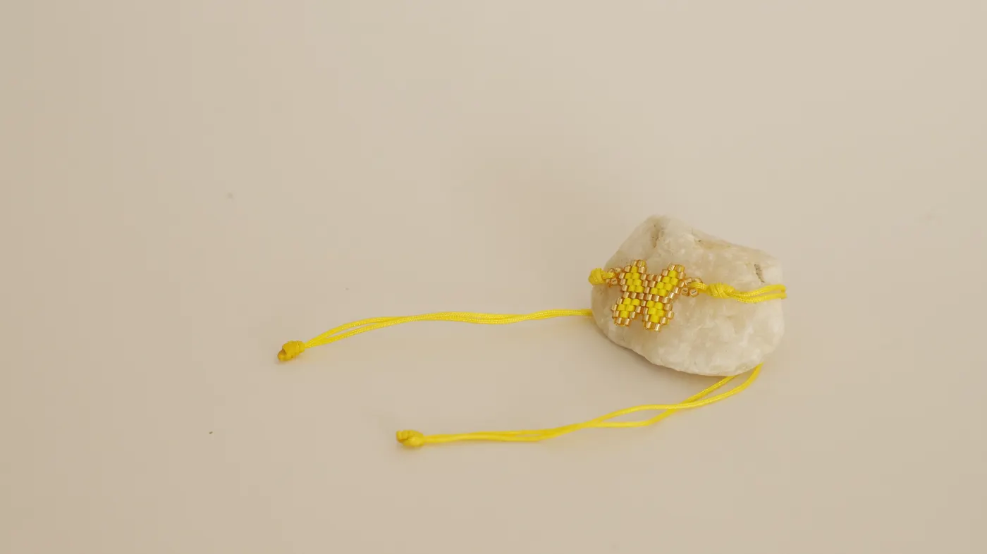 Bracelet with adjustable yellow cords