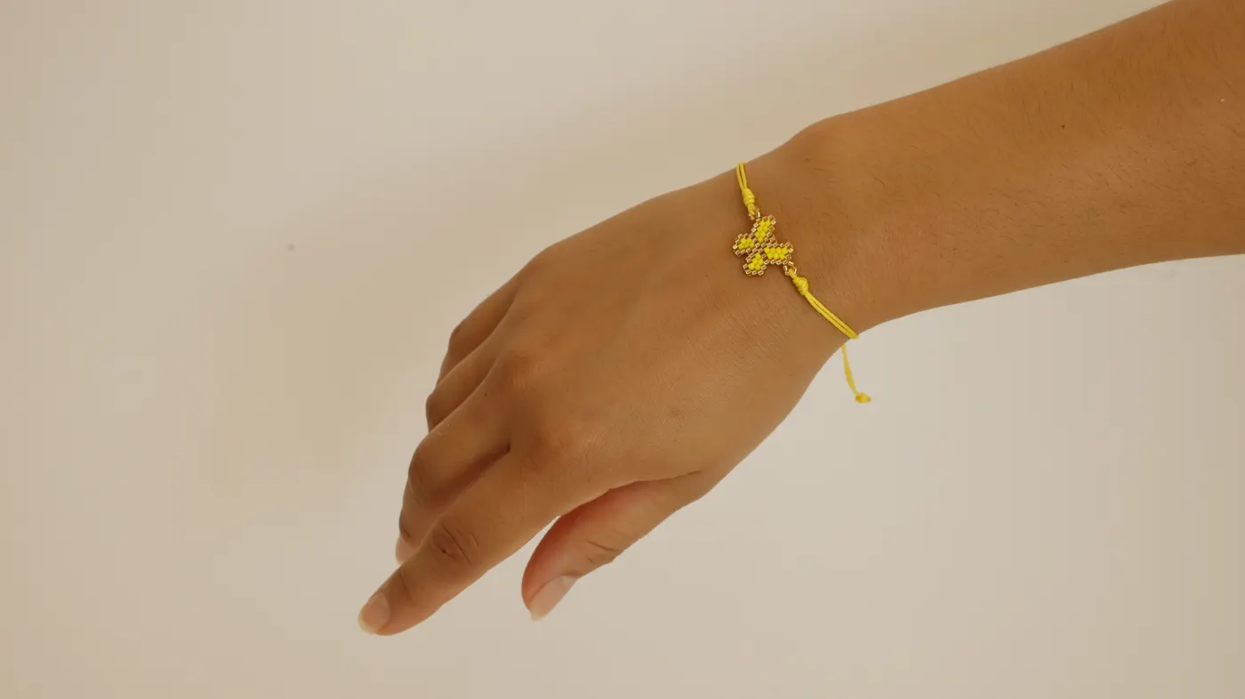 Yellow butterfly bracelet worn on a wrist
