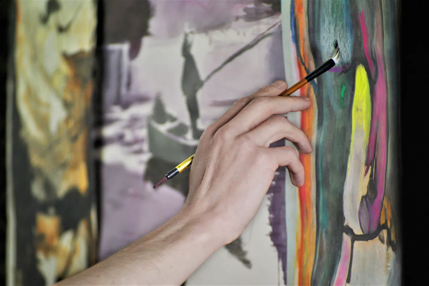 Close-up of a hand painting with a brush
