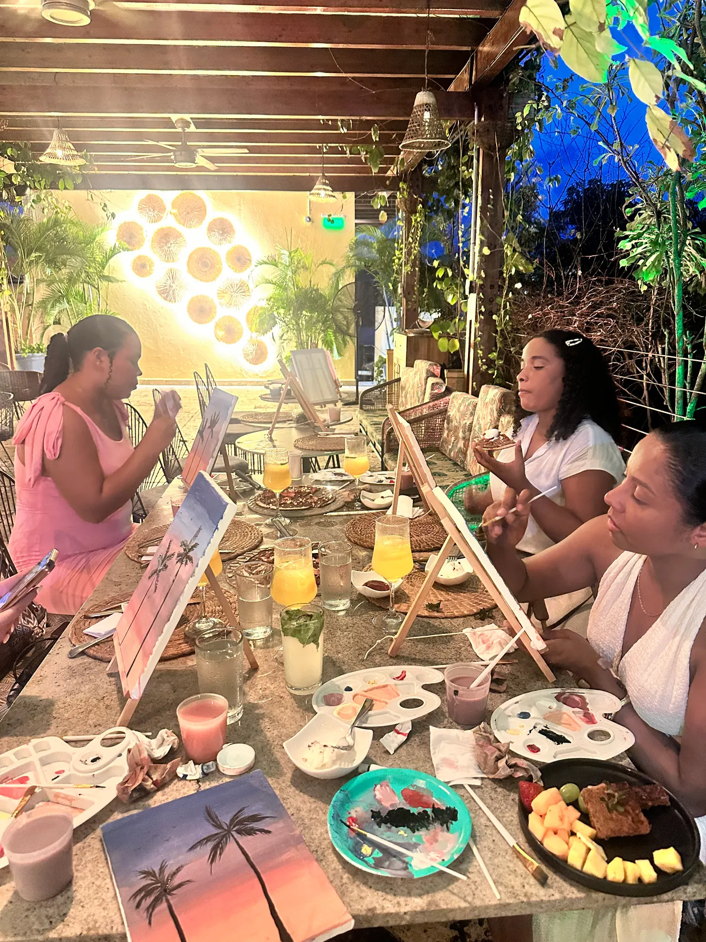 Guests painting at easels during the art and brunch experience