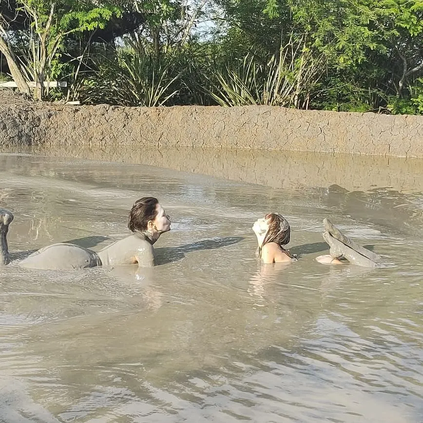 Two people soaking in a medicinal mud pool
