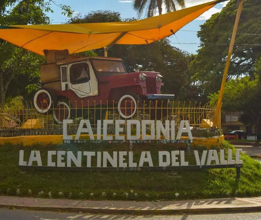 Willys jeep monument above the Caicedonia, la Centinela del Valle sign