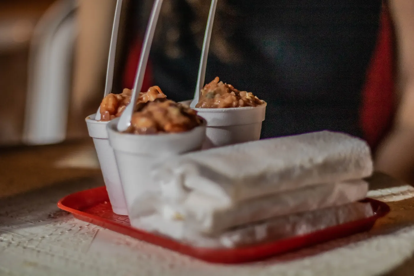 Cups of fried street snacks served with napkins