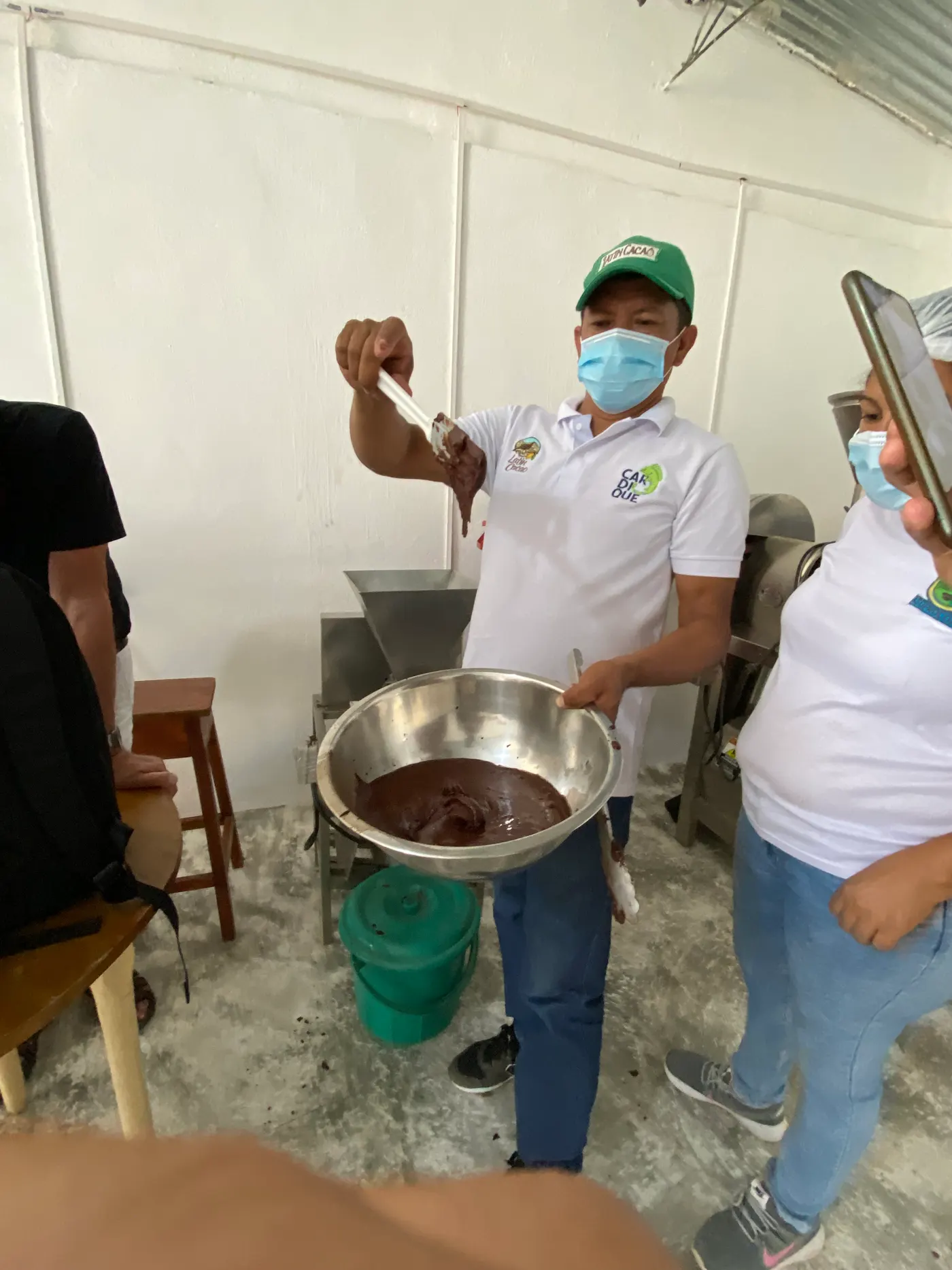 Cacao being prepared in a metal bowl at a chocolate workshop