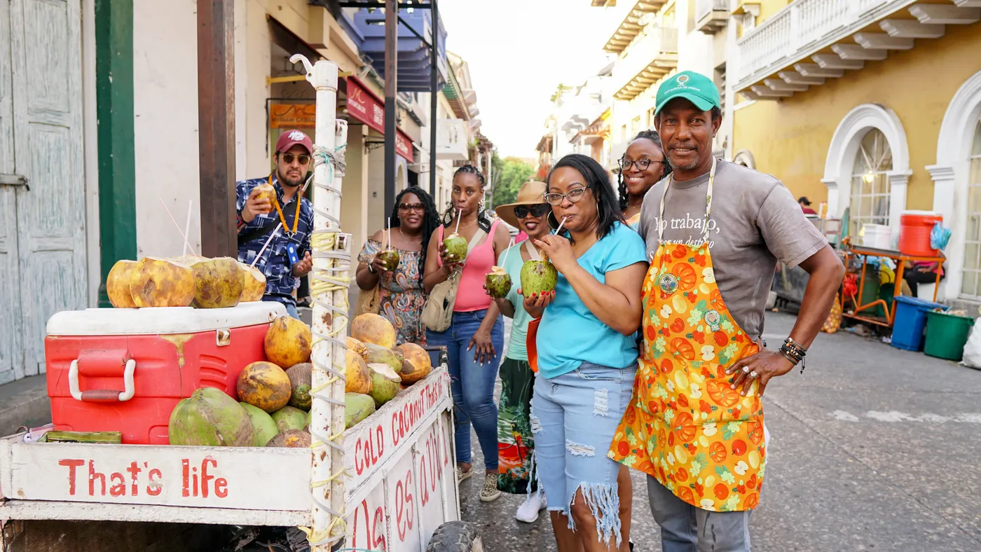 Fruit vendor and visitors on a street in the old town